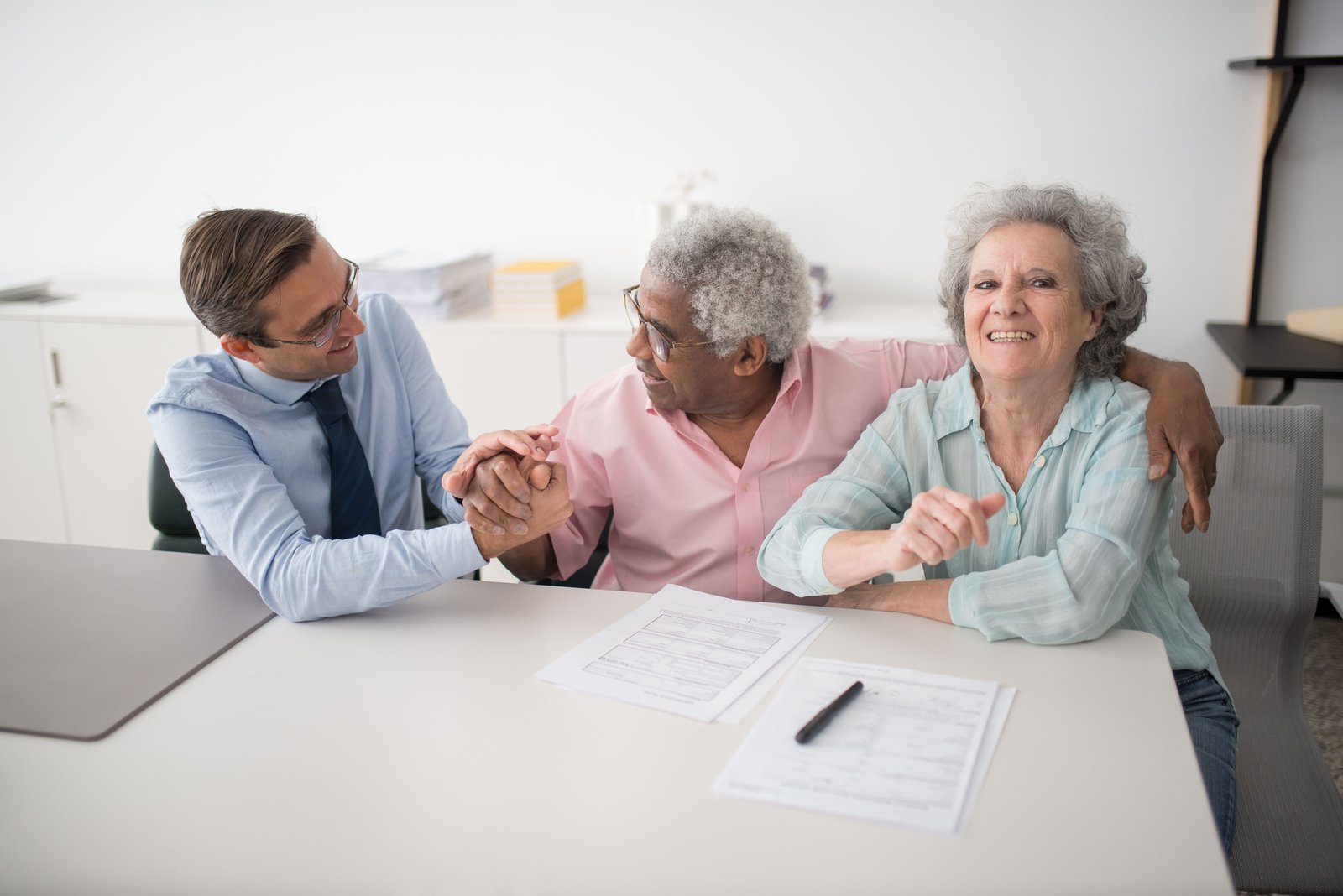 Happy customers meeting a financial services executive